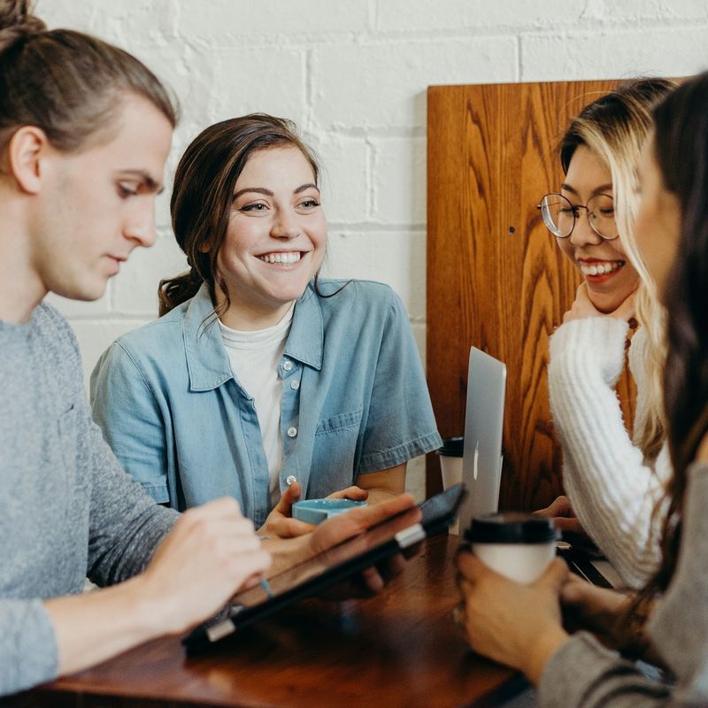 Colleagues laughing together over coffee