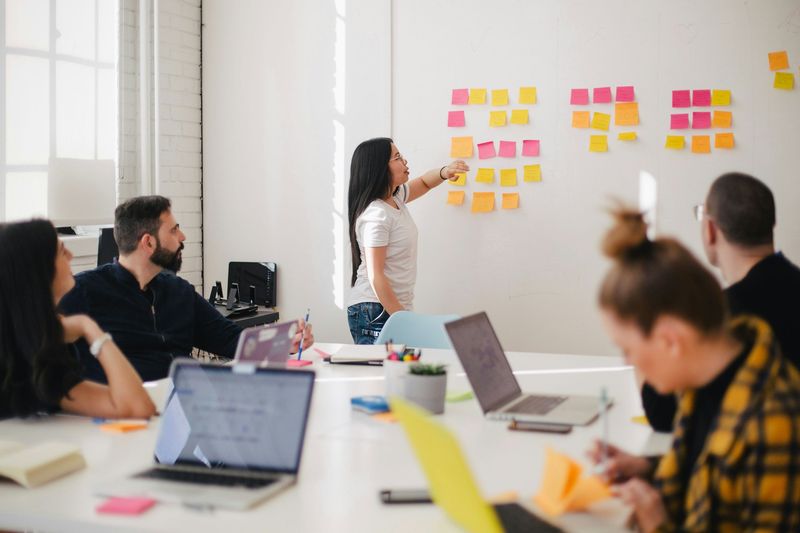 Team workshop with a leader at a sticky-note board
